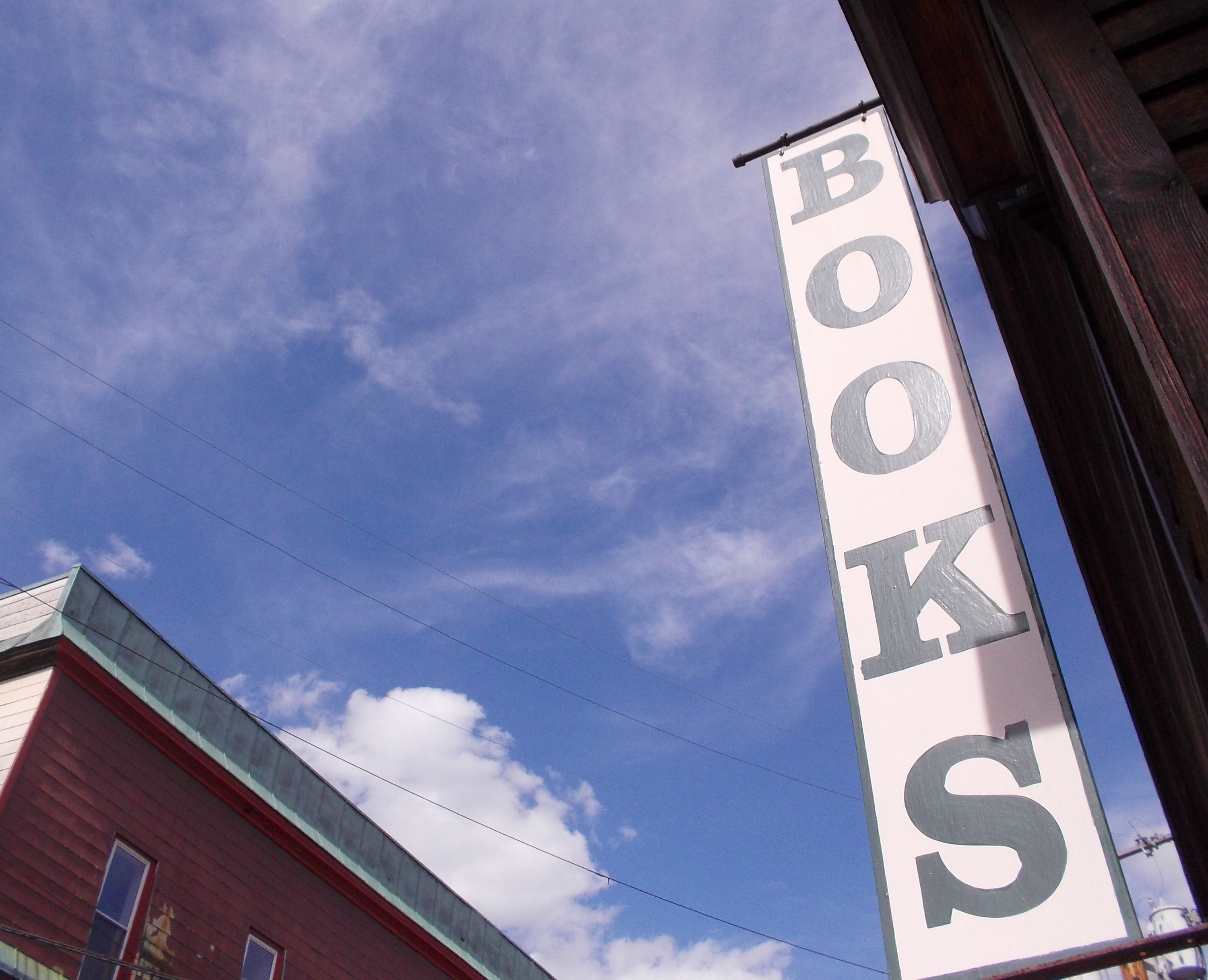 BOOKS blue sky red corner. photo Jen Austin