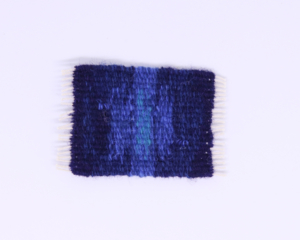 Miniature dark and light blue rug with white fringe, 2” x 3” 