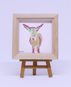 Miniature green, red, and gold painting of goat, 2 ¼” x 2 ¼”