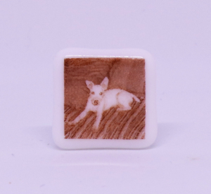Miniature sephia photo fused glass of dog on a couch, 