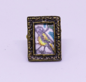 Miniature pencil drawing of a yellow bird in frame, 3/4” x ½”