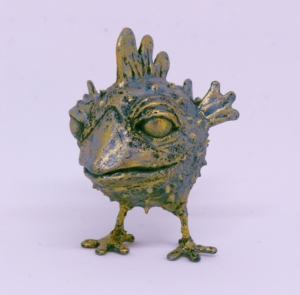Miniature mixed media sculpture of a puffer-chicken (a pufferfish with the face of a chicken and the body of a pufferfish)