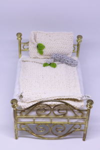 Miniature white and silver crochet bedsheet, 5 ½” X 4” X 2 ½”