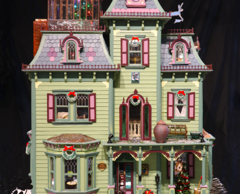 Front of the Painted Lady Victorian filled with miniature work from over 100 artists